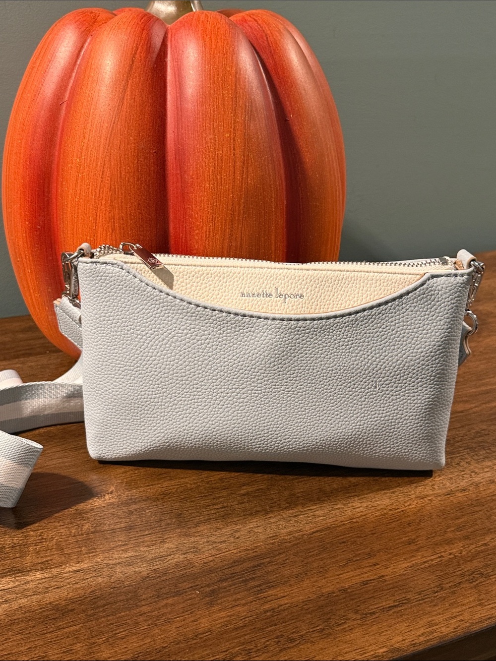 Nanette Lepore light gray and cream pebbled leather crossbody with striped strap